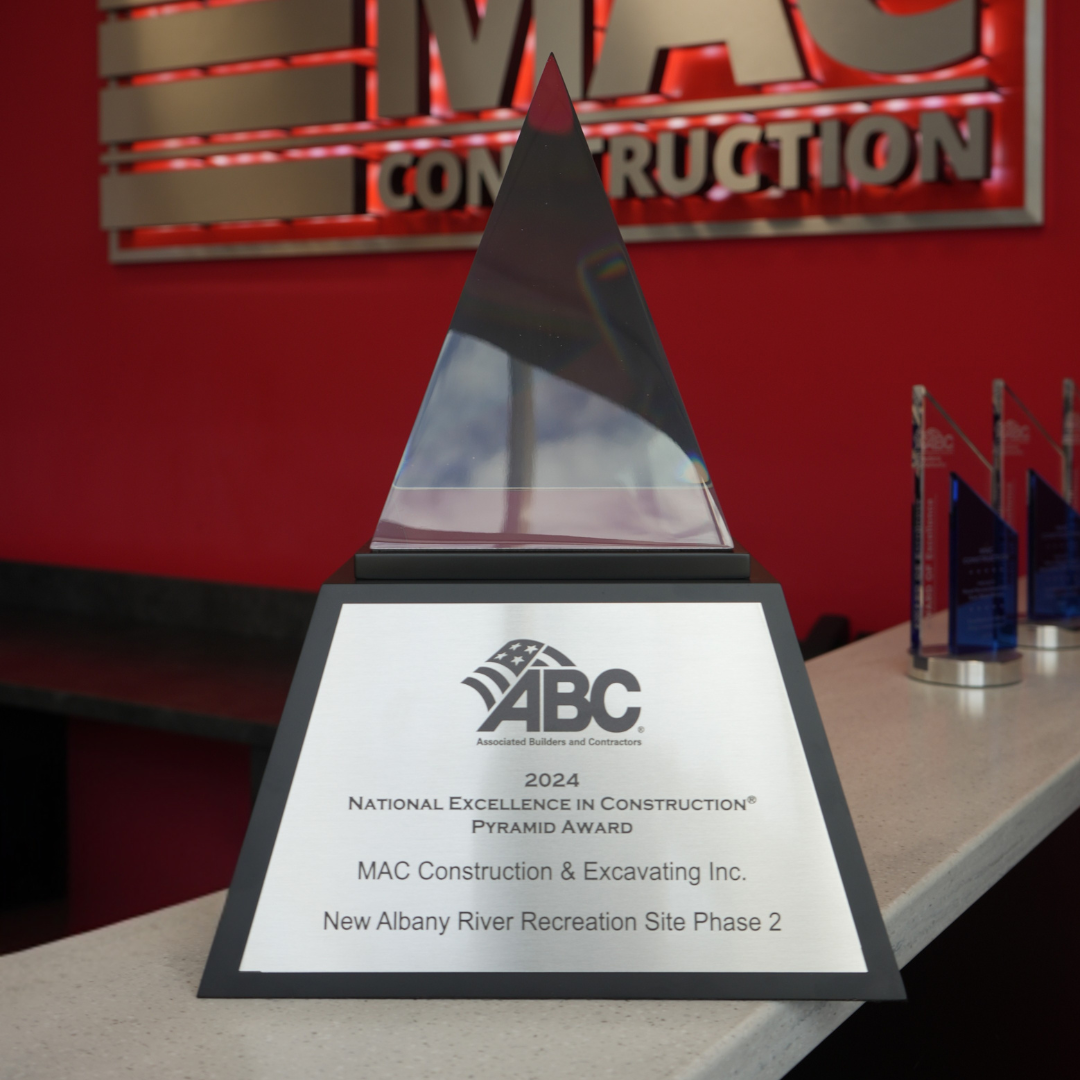 Pyramid-shaped glass award on a metal base with the ABC logo and plaque: 2024 National Excellence in Construction Pyramid Award for MAC Construction & Excavating Inc., New Albany River Recreation Site Phase 2.